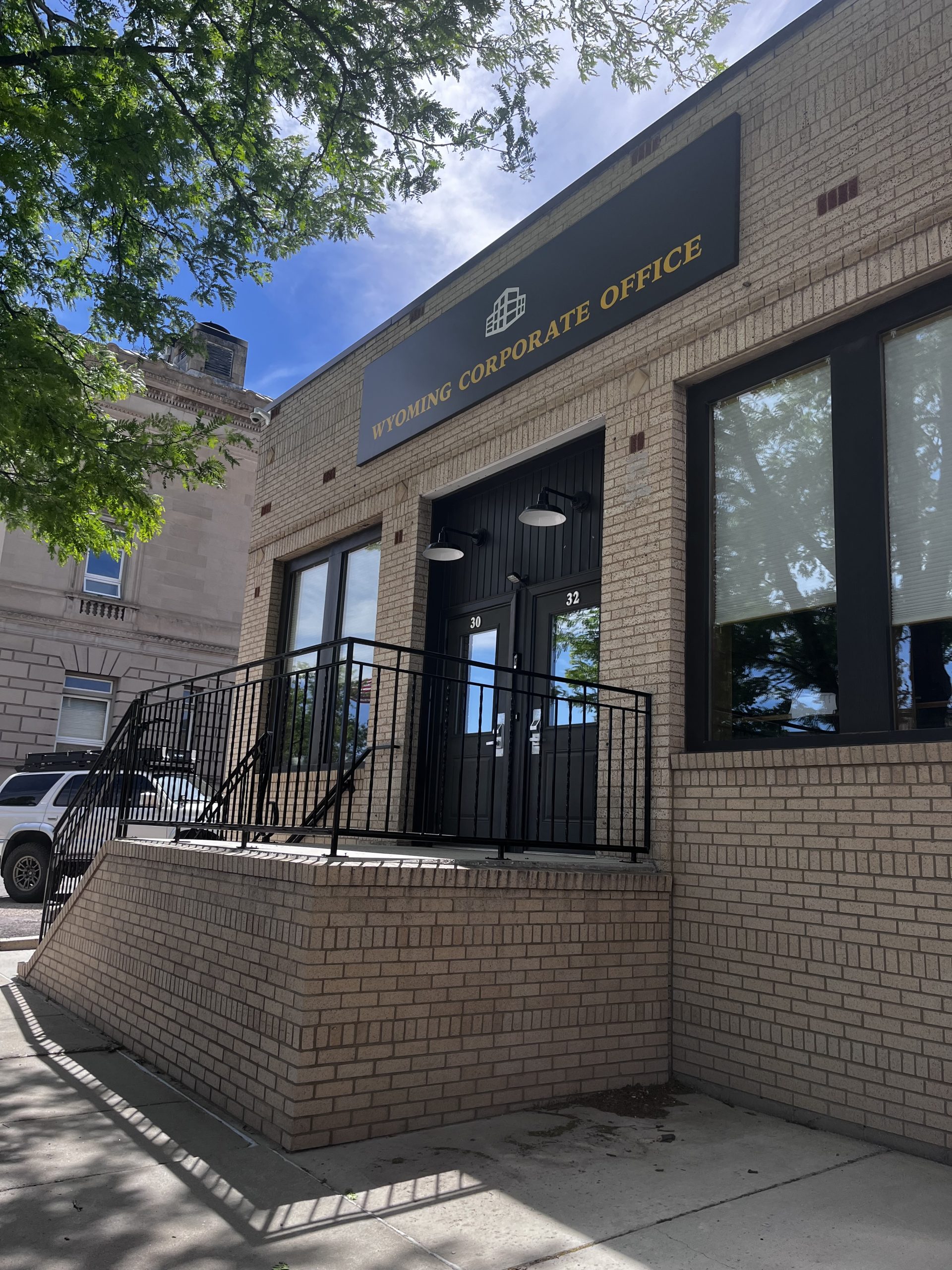 The exterior to a brick building with a sign reading "Wyoming Corporate Office."