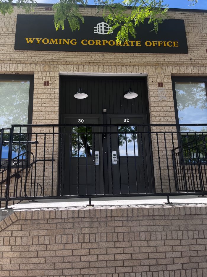 The exterior to a brick building with a sign reading "Wyoming Corporate Office."