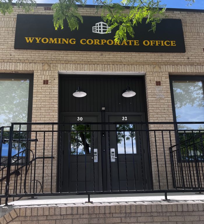 The exterior to a brick building with a sign reading "Wyoming Corporate Office."